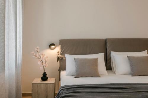 a bedroom with a large bed with white pillows at Klio Seafront House, Sami Kefalonia in Sami