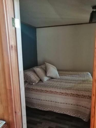 Кровать или кровати в номере Casa de campo Santa Cruz