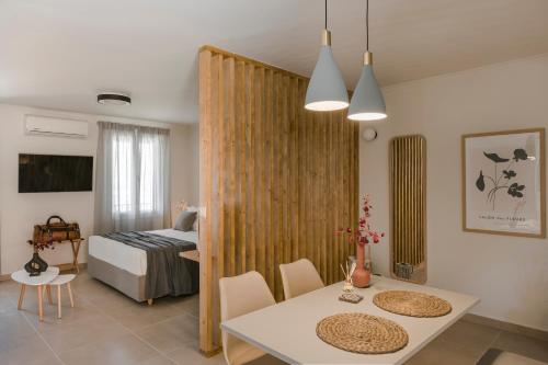 a living room with a dining table and a bedroom at Klio Seafront House, Sami Kefalonia in Sami