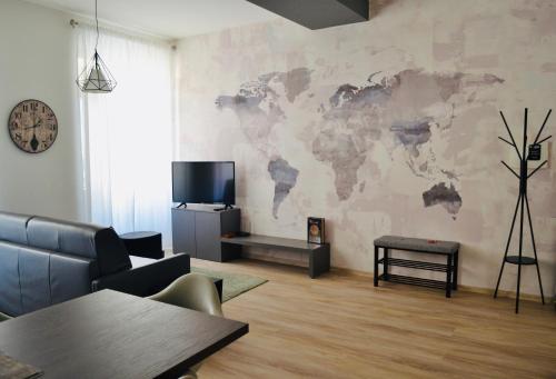 a living room with a map of the world on the wall at RivApartmentsDowntowN Travel in Riva del Garda