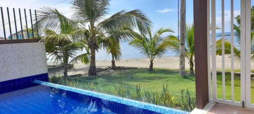 a view from the balcony of a resort with a swimming pool at Casa frente al mar con piscina in Coveñas