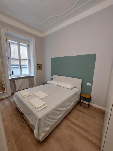 a white bedroom with a large bed in a room at Perfect Place in Porta Venezia in Milan