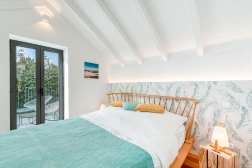 a bedroom with a bed and a balcony at The Hideaway Madeira in Prazeres