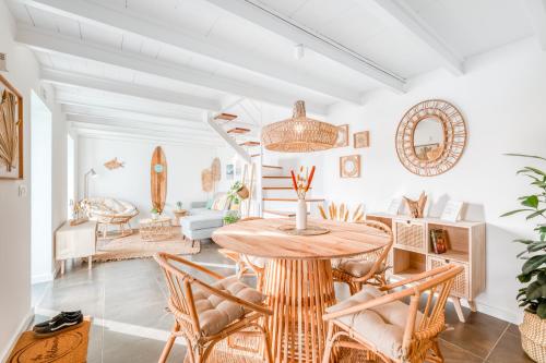 a living room with a wooden table and chairs at The Hideaway Madeira in Prazeres