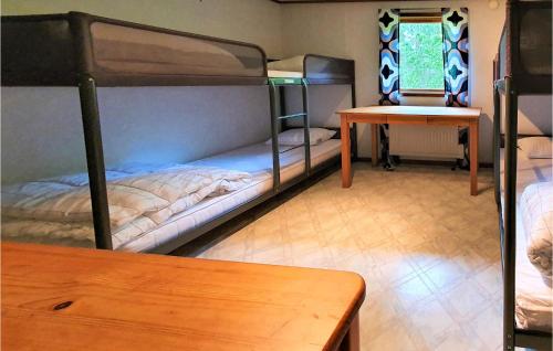 um quarto com 2 beliches e uma mesa em 2 Bedroom Gorgeous Home In Lngaryd em Långaryd
