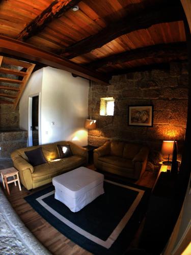 a living room with a couch and a table at Vila Cavalica in Bustelo