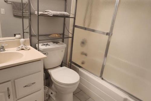a bathroom with a toilet and a shower and a sink at Molino in Las Vegas