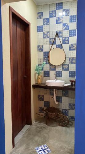a bathroom with a sink and a mirror at Milagres Retrô- Studio in São Miguel dos Milagres