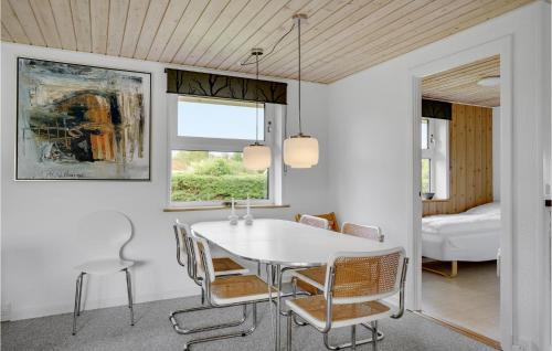 a dining room with a white table and chairs at 3 Bedroom Pet Friendly Home In Hejls in Hejls