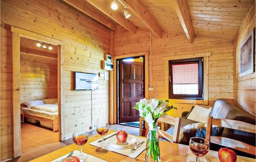 ein Holzzimmer mit einem Tisch und Weingläsern in der Unterkunft Nice Home In Sianozety With Kitchen in Sianożęty