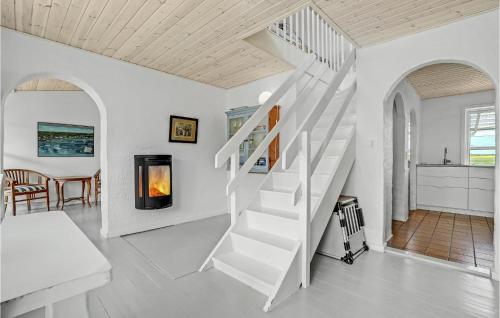 a white staircase in a white living room with a table at Gorgeous Home In Vestervig With Wifi in Vestervig