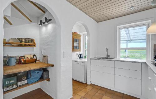 a kitchen with white cabinets and a window at Gorgeous Home In Vestervig With Wifi in Vestervig