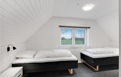 Cette chambre blanche dispose de 2 lits et d'une fenêtre. dans l'établissement 3 Bedroom Awesome Home In Spttrup, à Spottrup