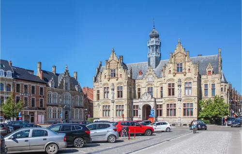 a large building with cars parked in front of it at 4 Bedroom Awesome Home In Langemark in Langemark