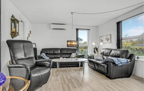 un soggiorno con sedie in pelle e un tavolo di 3 Bedroom Nice Home In Nordborg a Nordborg