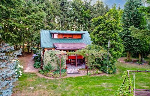 a house in the middle of a yard at 1 Bedroom Amazing Home In Policko in Luboradz