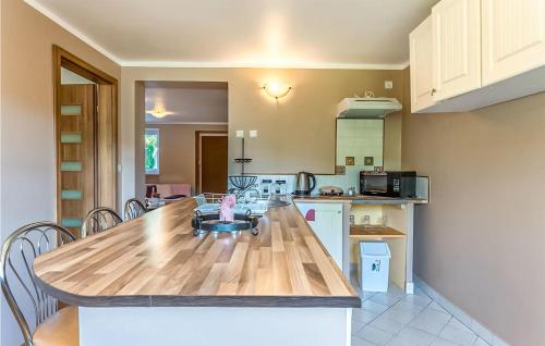 a kitchen with a table with a child sitting in a chair at Gorgeous Apartment In Szklarska Poreba With Wifi in Szklarska Poręba