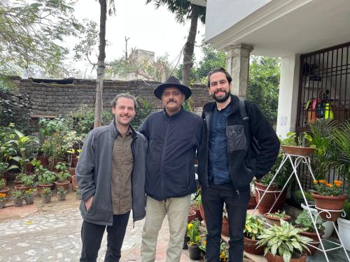a group of three men standing in front of a house at Alibaba’s Indiana Homestay in Agra
