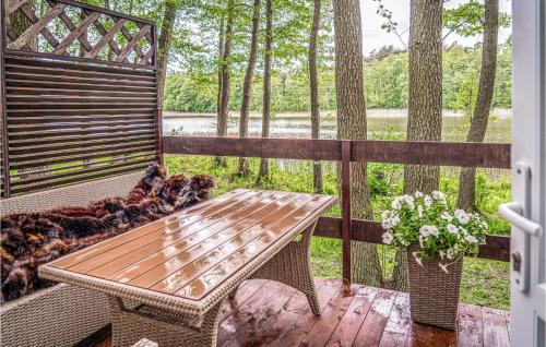 a dog laying on a bench on a porch at Cozy Home In Sulnowo With Kitchen in Sulnówko