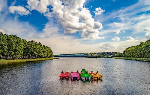 a group of people riding on a raft in a river at Cozy Home In Sulnowo With Kitchen in Sulnówko