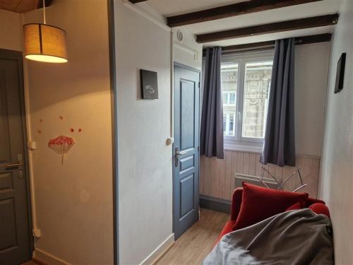 uma sala de estar com um sofá vermelho e uma janela em Appartement Mont-Dore, 3 pièces, 4 personnes - FR-1-415-145 em Le Mont-Dore