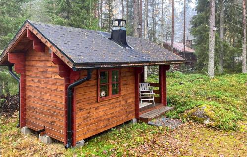 a small cabin with a chair in a forest at 2 Bedroom Lovely Home In Forsns 