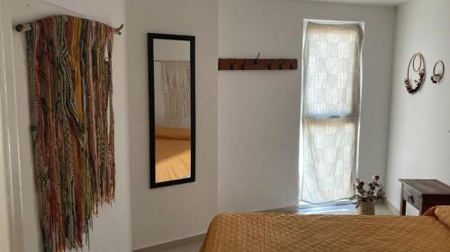 a bedroom with a mirror and a bed and a window at TORRES H in Córdoba