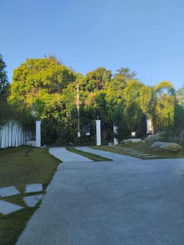 a walkway in a park with trees in the background at Casa LeoMa in Cavite
