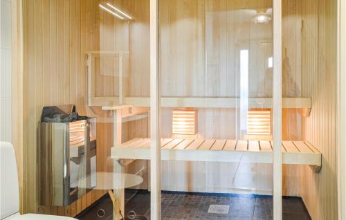 a room with wooden shelves and a table and a window at Awesome Home In Vrena With Wifi in Vrena