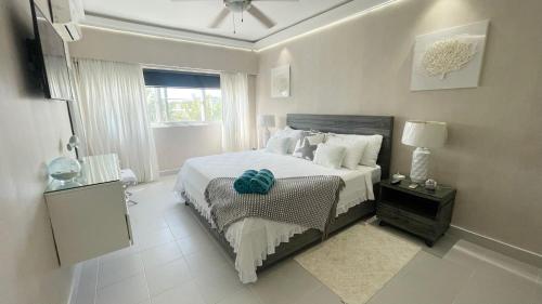 a bedroom with a large bed and a window at Relaxing 2 Bedroom Ocean View with Pool Close to the Beach in Punta Cana