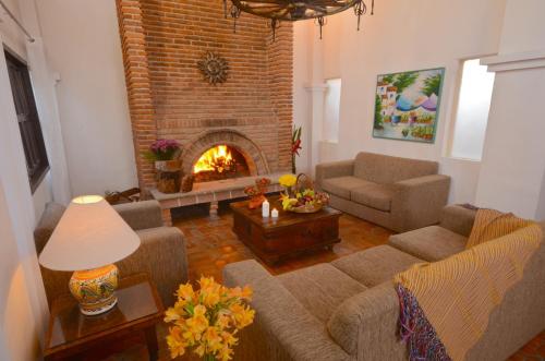 a living room with a couch and a fireplace at Villas Danza del Sol in Ajijic