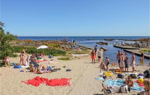 a group of people on the beach at a beach at Nice Apartment In Svaneke With Wifi in Svaneke