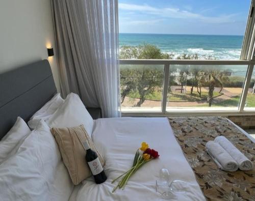 a bedroom with a bed with a view of the ocean at sea view apartment in Bat Yam