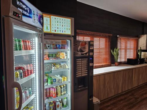a refrigerator with its door open in a kitchen at Arena eSports Hotel @ Bugis Village in Singapore