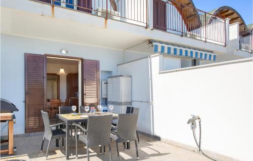 a balcony with a table and chairs on a patio at Casa Loughry in Badolato