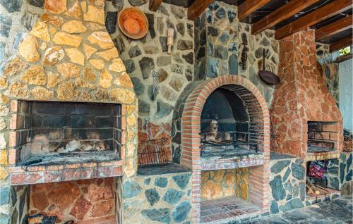 a stone wall with two brick ovens on it at Lovely Home In Mecina Bombarón in Mecina Bombarón