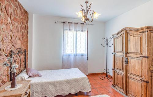 a bedroom with a bed and a dresser and a window at Lovely Home In Mecina Bombarón in Mecina Bombarón