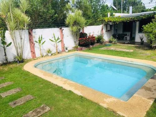 a large blue swimming pool in a yard at Panglao Bed and Breakfast Exclusive Villa in Panglao