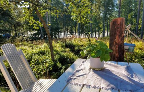 eine Topfpflanze auf einem Tisch neben einem Stuhl in der Unterkunft Gorgeous Home In Degerfors With Kitchen in Degerfors