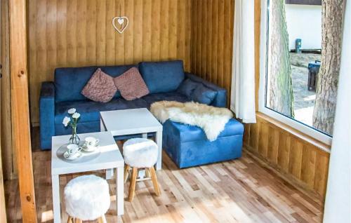 a living room with a blue couch and a table at Awesome Home In Sulnowo With Sauna And Wifi 