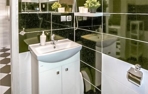 a bathroom with a sink and a glass wall at Beautiful Home In Grzybowo With Wifi in Grzybowo