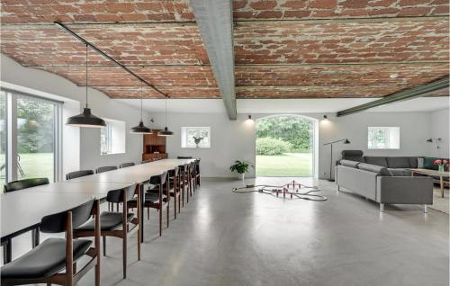 a large dining room with a long table and chairs at 7 Bedroom Stunning Apartment In Varde in Varde