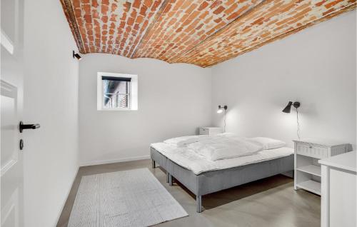 a bedroom with a bed and a wooden ceiling at 7 Bedroom Stunning Apartment In Varde in Varde