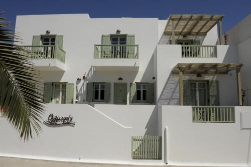 a white building with a sign on the side of it at Almyris in Adamas