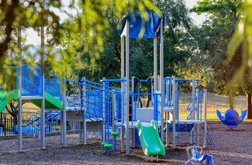 a playground with blue and green playground equipment at Bright Valley Holiday Park in Bright