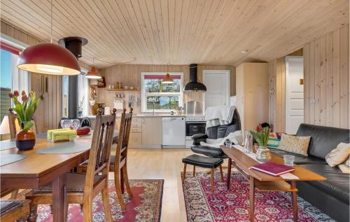 a kitchen and living room with a table and chairs at 2 Bedroom Beautiful Home In Otterup in Otterup