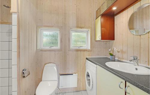 a bathroom with a toilet and a sink at Cozy Home In Holbk With Wifi in Holbæk