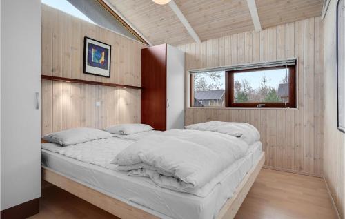 a large bed in a room with a window at Nice Home In Grenaa With Sauna in Grenå
