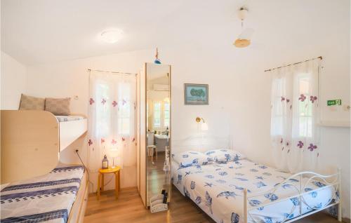 a bedroom with two beds and a mirror at Beautiful Home In Stari Grad With Wifi in Stari Grad