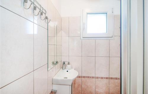 a bathroom with a toilet and a sink and a window at Beautiful Home In Stari Grad With Wifi in Stari Grad